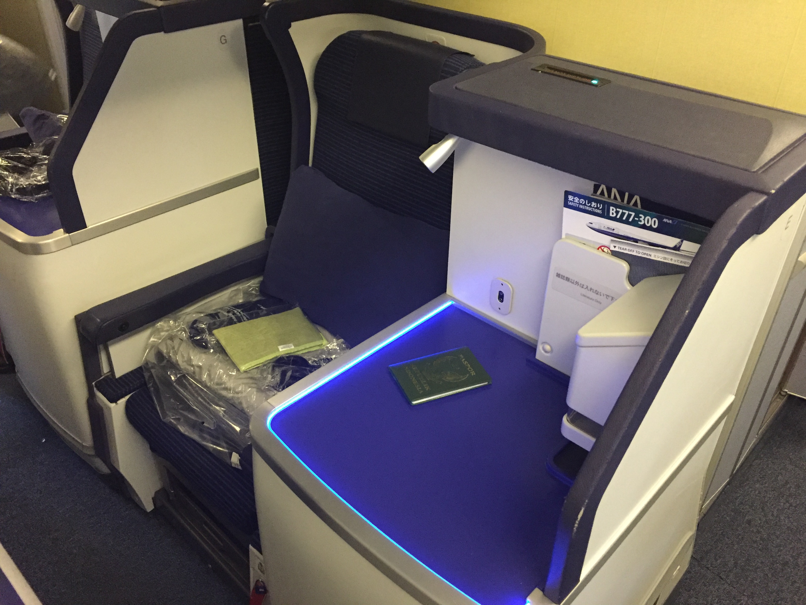 ANA business class seat on the Boeing 777-300 with passport on the side console