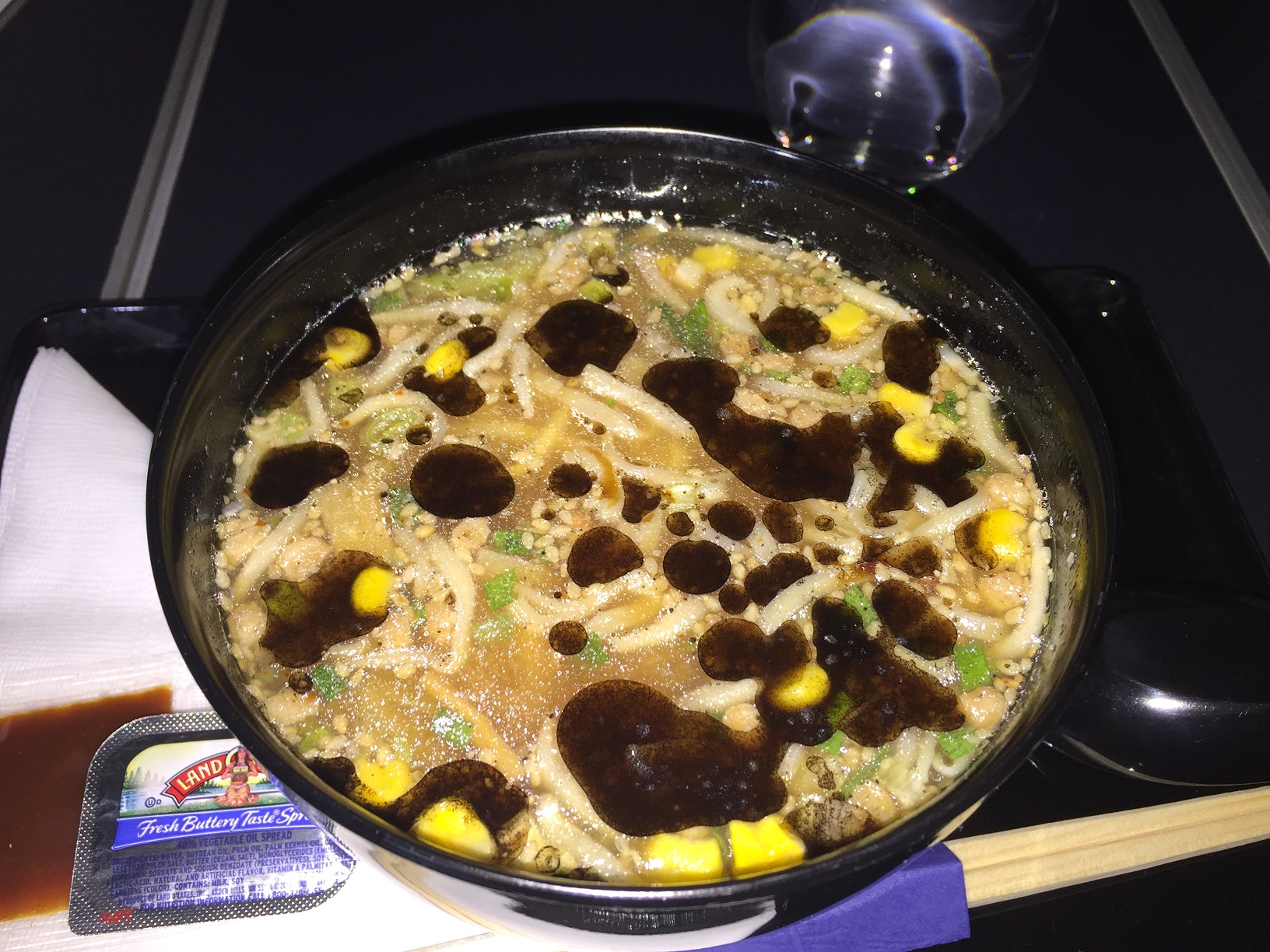 ANA in-flight ramen with corn, scallions, ground pork, and a Land O'Lakes butter packet on the side