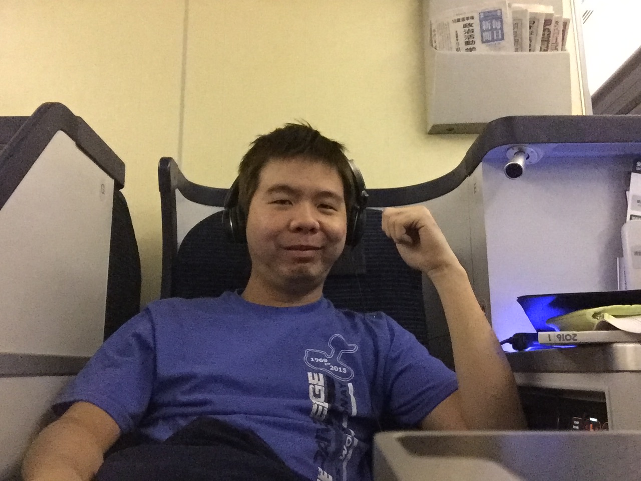 Martin in the seat wearing Bose headphones, settled in for the flight