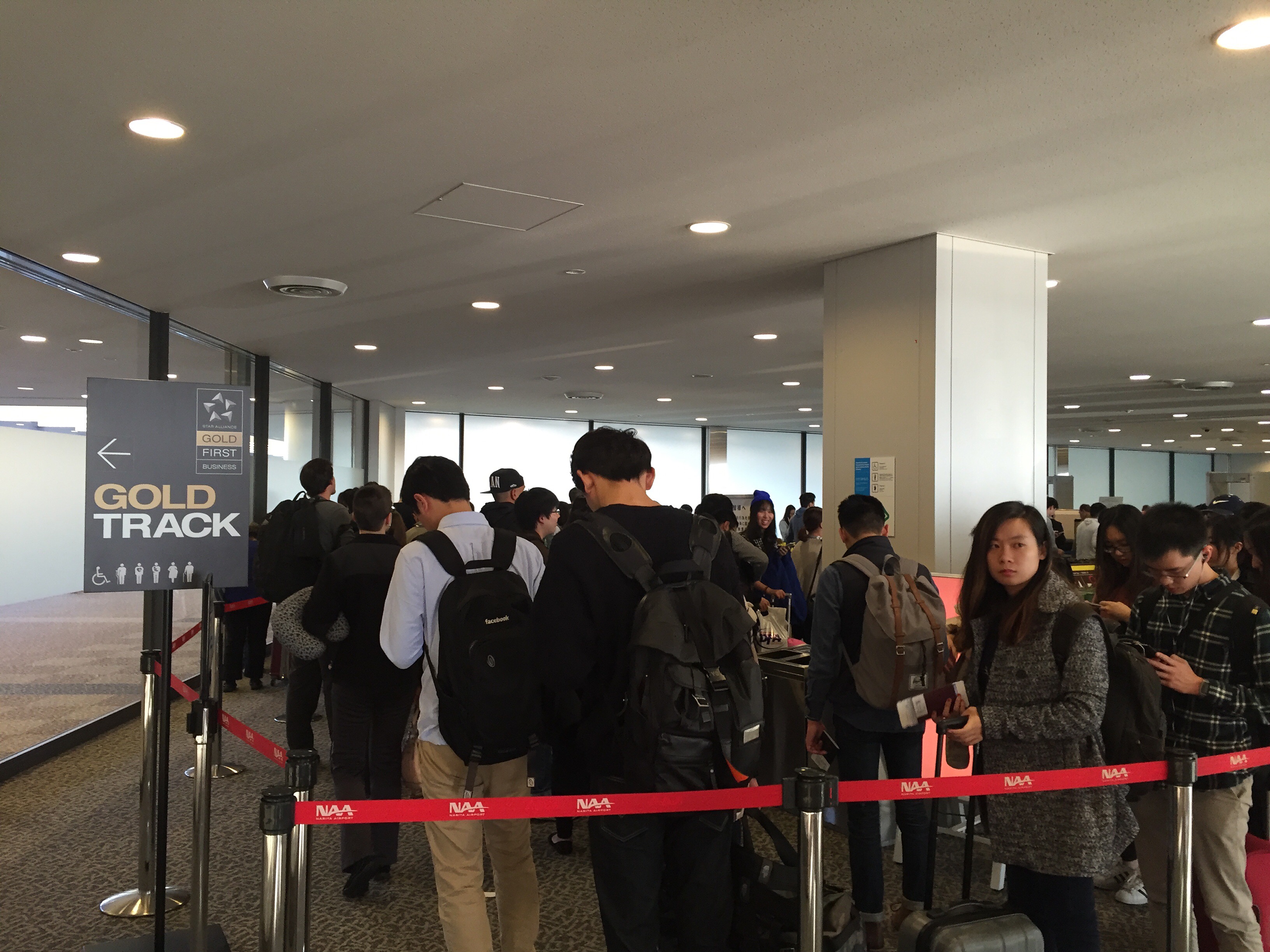 The Gold Track priority lane at Narita with crowds queuing on the right