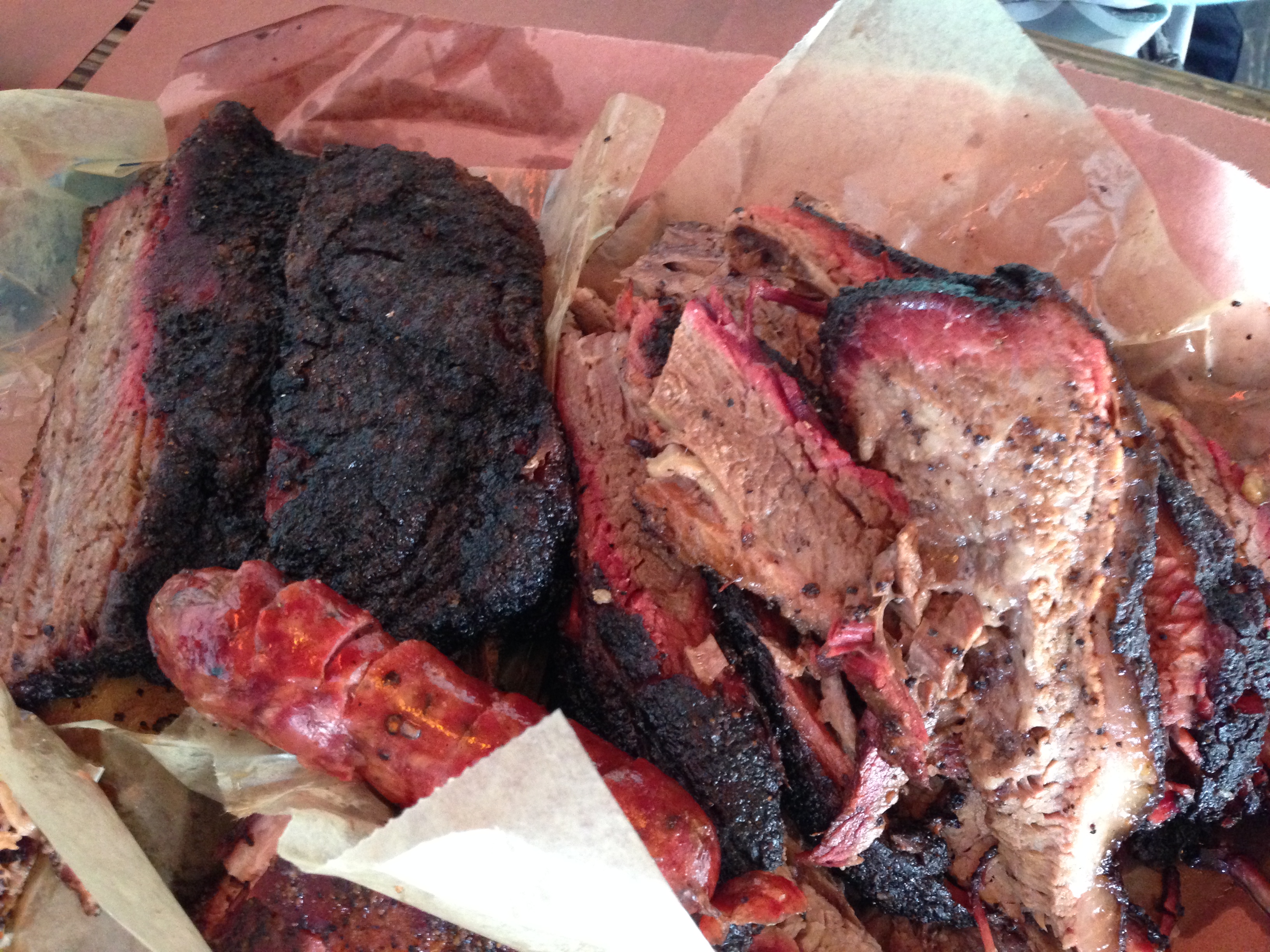 Brisket, beef ribs, and sausage on butcher paper at Franklin BBQ, Austin