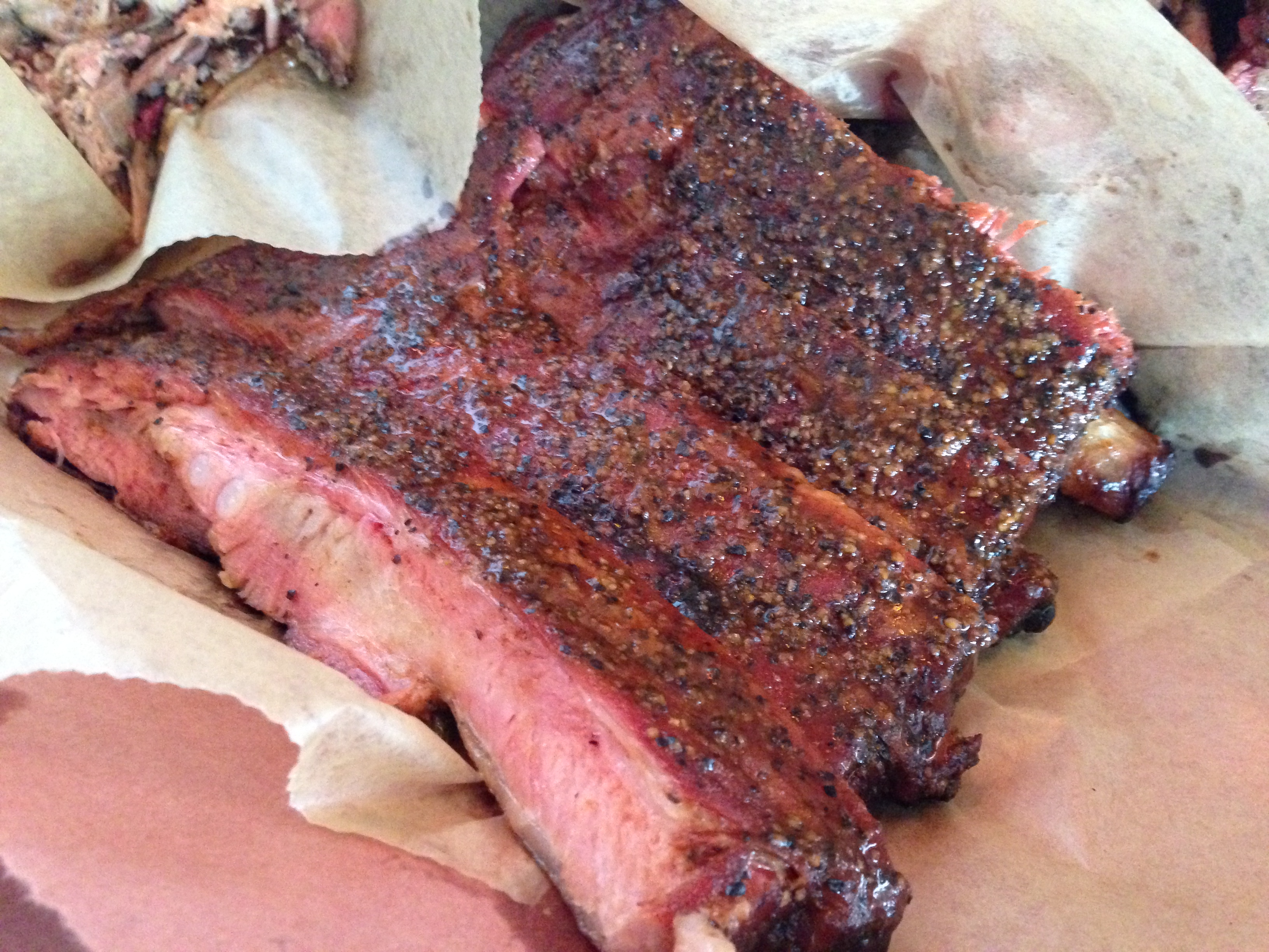 Pork ribs with a deep bark and pink smoke ring