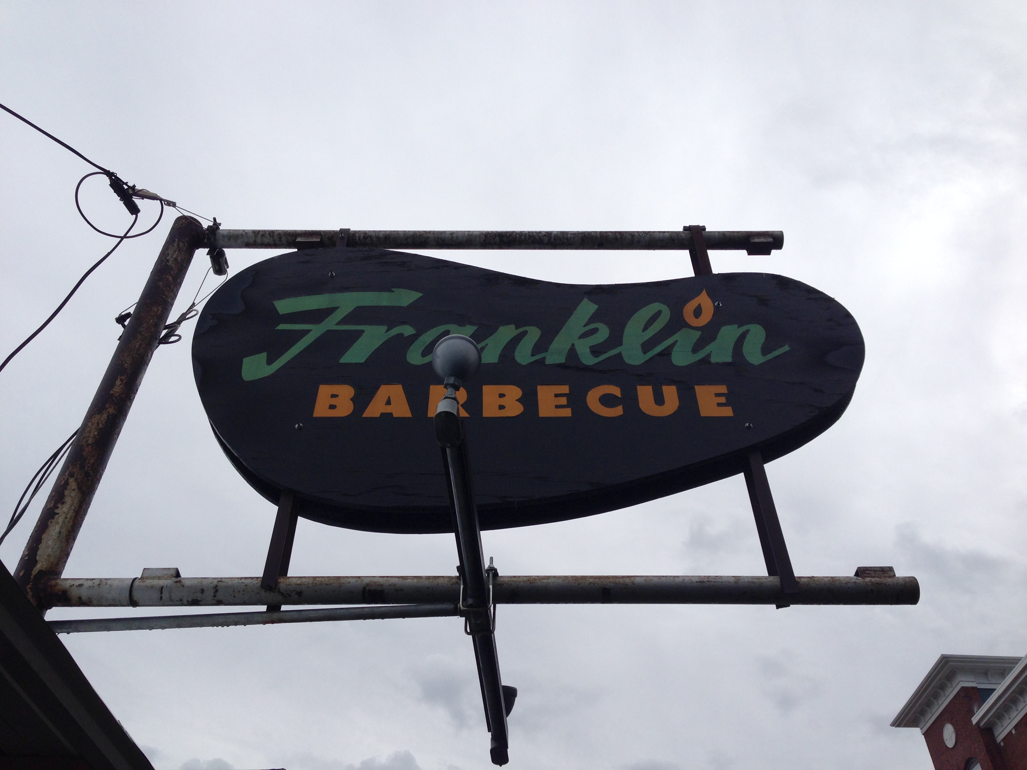 The Franklin Barbecue sign against an overcast Austin sky