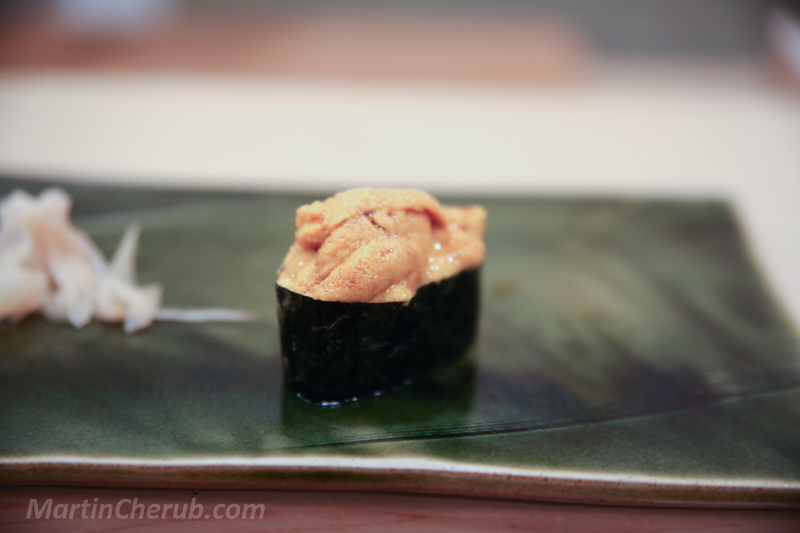 Uni gunkan — creamy orange sea urchin in nori wrap