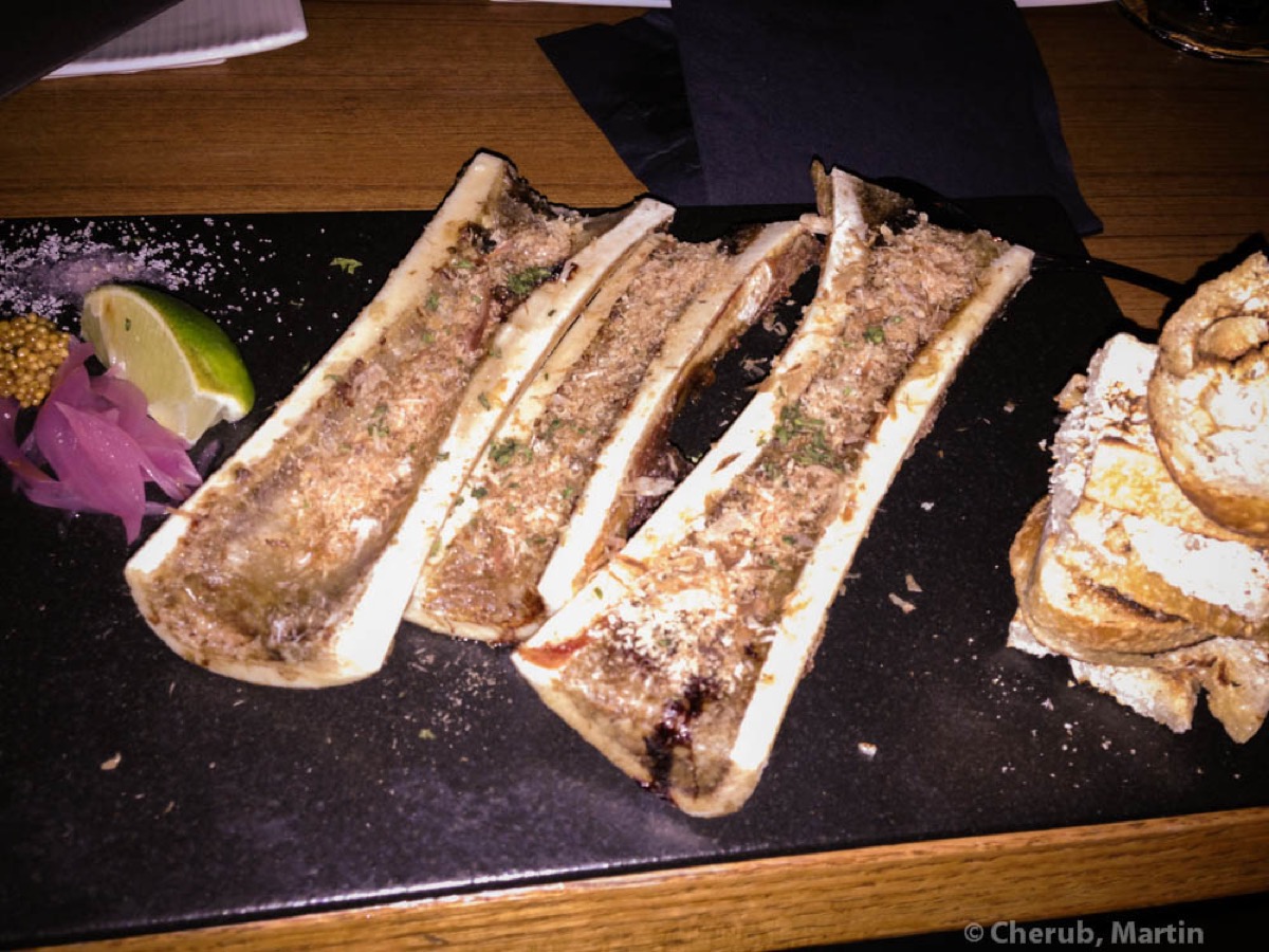 Miso crusted bone marrow served on a slate plate at Kata Robata