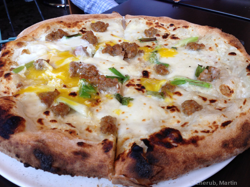 Sausage pizza with egg, scallions, and charred crust