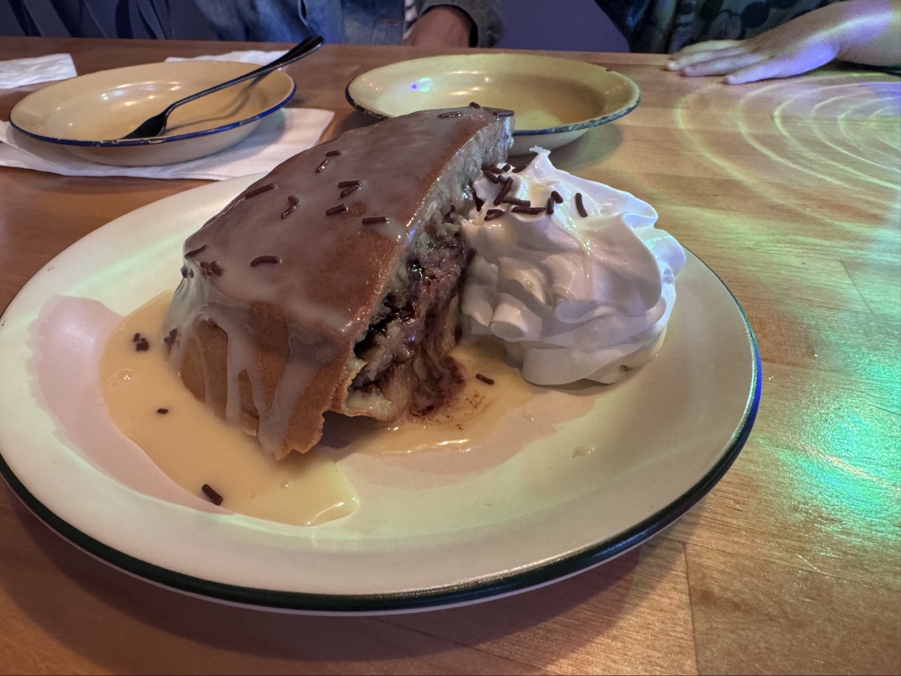 Sweet martabak with chocolate, condensed milk, sprinkles, and whipped cream