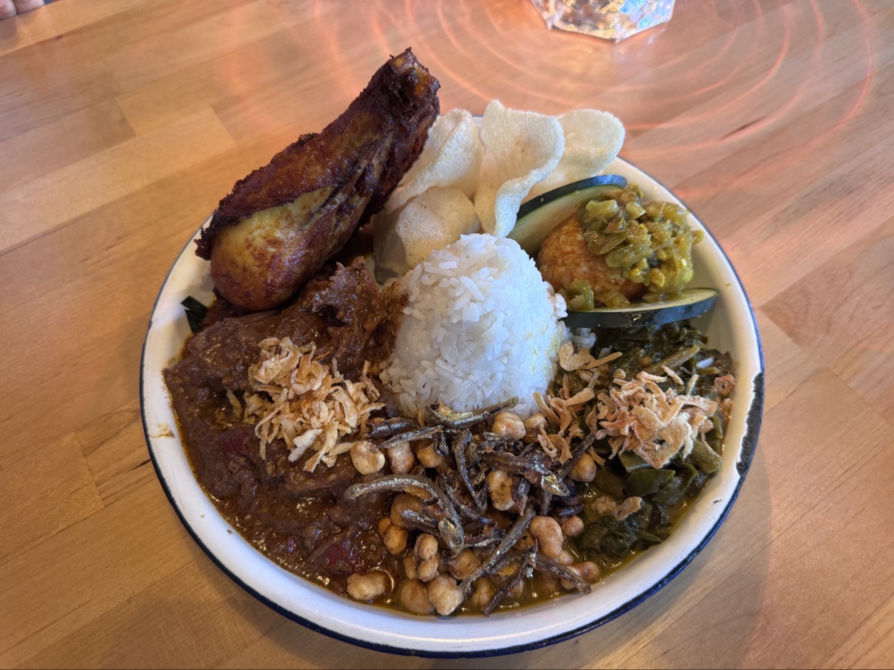 Nasi padang platter with beef rendang, fried chicken, rice, and crackers at Rasa Rasa in San Francisco