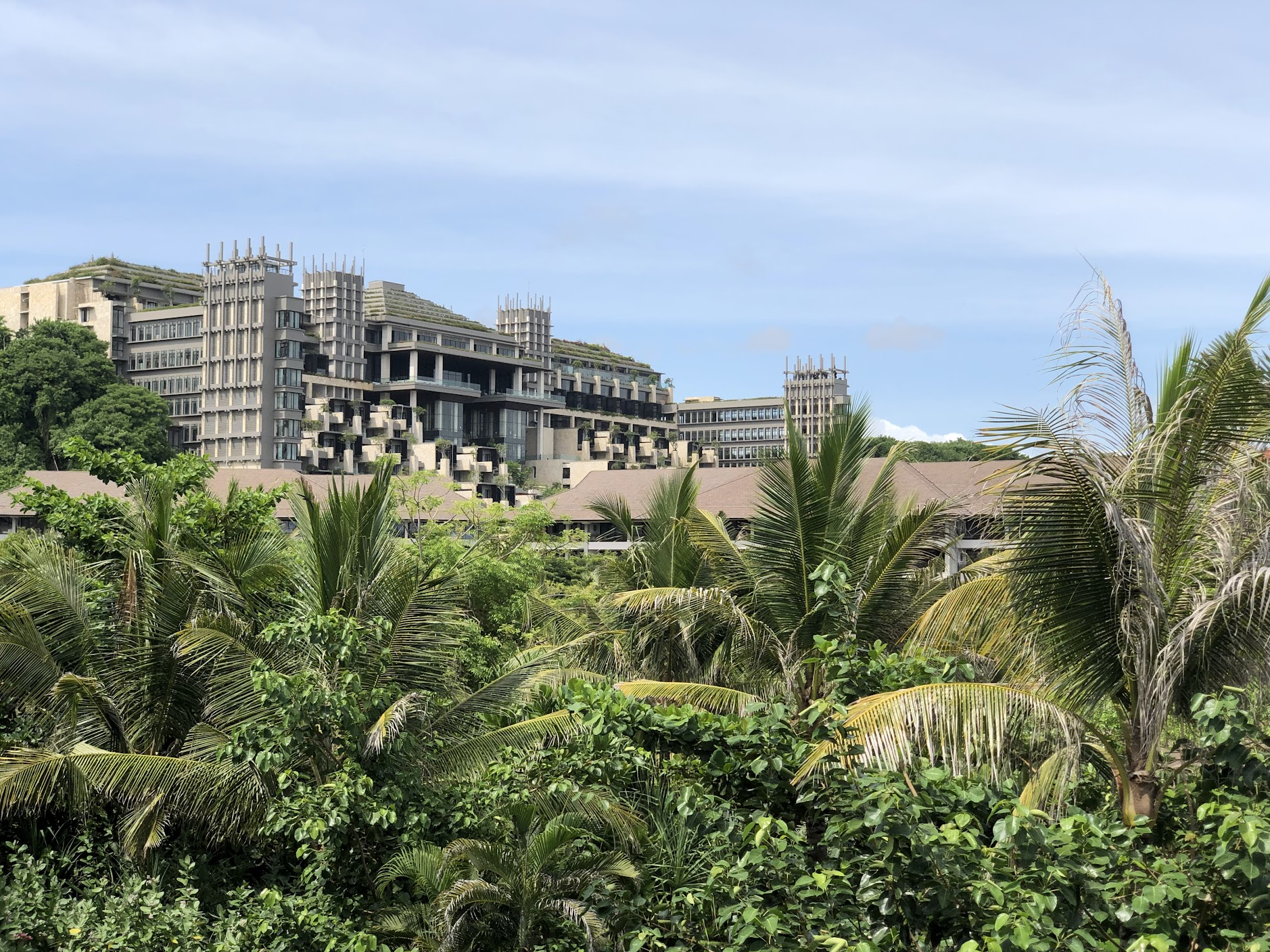 The Ritz-Carlton Bali main building rising above the palm trees
