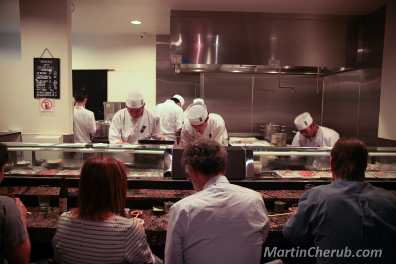 Japanese chefs working behind the sushi counter at Sushi Zo