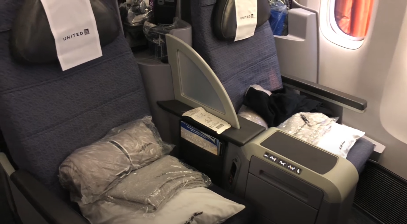 United Airlines Business Class seats in a 2-2 configuration with branded headrest covers
